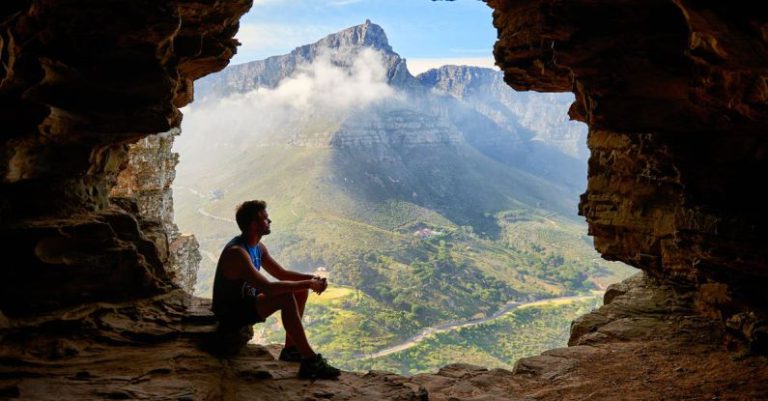 Adventure - Photo of Man Sitting on a Cave