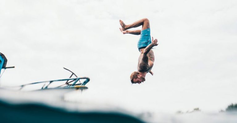 Adventure - Man Wearing Blue Shorts About to Dive on Body of Water