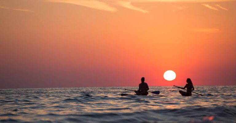 Adventure - Man and Woman Boat Rowing in Sea during Golden Hour