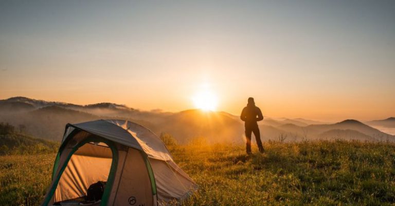 Hiking - Silhouette of Person Standing Near Camping Tent