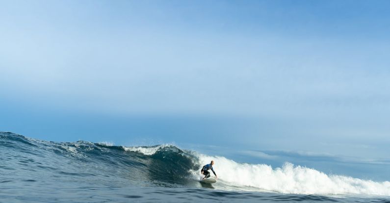 Surfing - A Person Surfing on the Sea