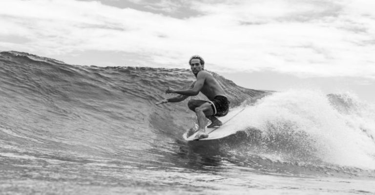 Surfing - Grayscale Photo of a Shirtless Man Surfing on Sea Waves