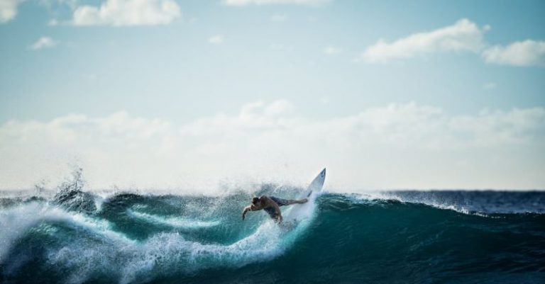 Surfing - Person Riding on White Surfboard Doing Surfing